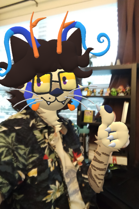 a photograph of the webmaster giving a thumbs up at his desk, which has been drawn over in Paint 3D to look like his fursona, a cat/sea otter/lobster.